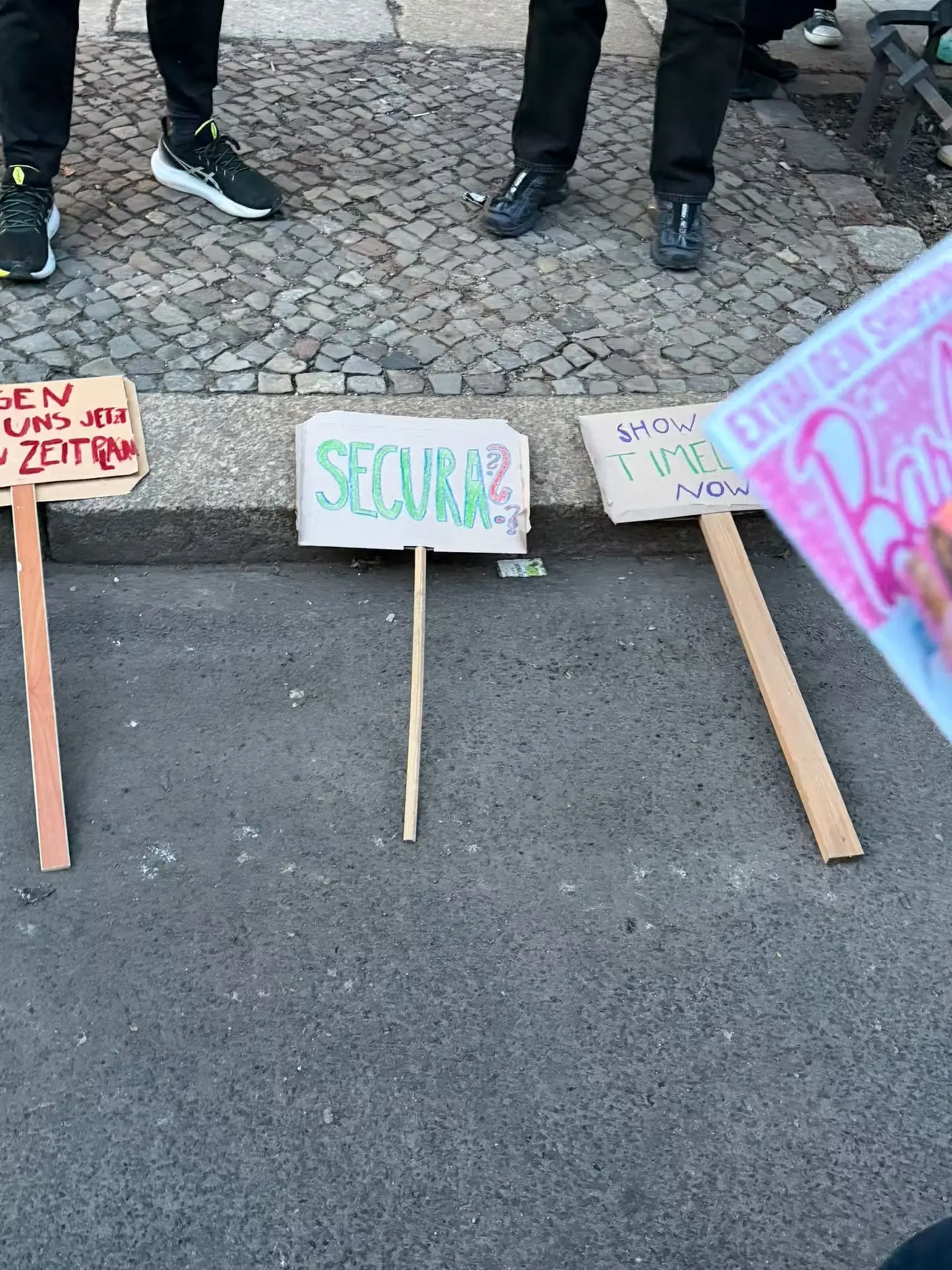 Signs with our demands and unanswered questions before the demo.